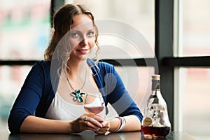 Young woman with a cognac at restaurant