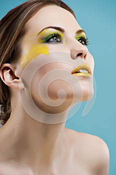 Young woman with colored glamour make-up