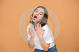 The young woman with colorful lollipop