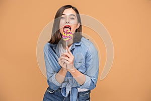 The young woman with colorful lollipop