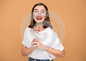 The young woman with colorful lollipop