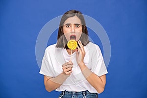 The young woman with colorful lollipop