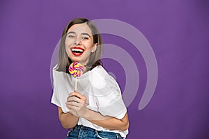 The young woman with colorful lollipop