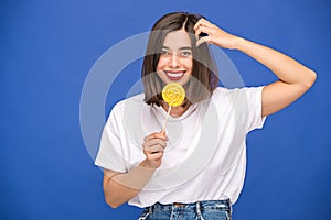 The young woman with colorful lollipop