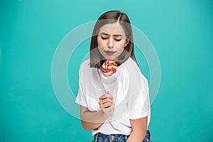 The young woman with colorful lollipop