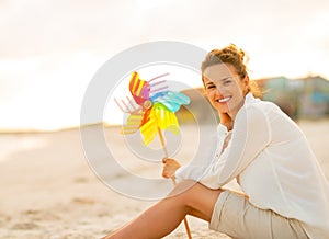 Young woman with colorful windmill toy