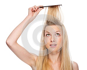 Young woman combing hair