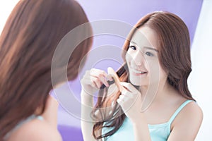 Young woman is combing hair