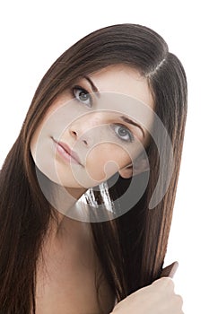 Young woman combing her hair