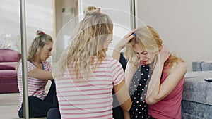 A young woman comforting a friend who is upset and crying. Support and friendship problems of adolescents and women