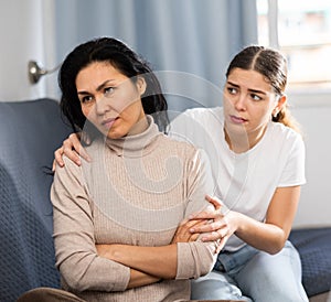 Young woman comforting her depressed female friend