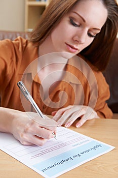 Young Woman Completing Employment Application Form photo