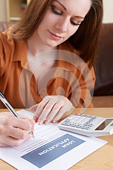 Young Woman Completing Loan Application Form