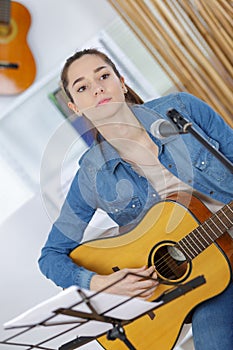 young woman compose song and play guitar