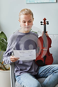 Young Woman Composing Music for Violin