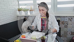 Young woman conducting chemical experiments at home.