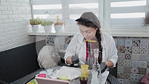 Young woman conducting chemical experiments at home.