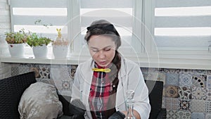 Young woman conducting chemical experiments at home.