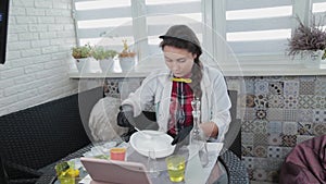 Young woman conducting chemical experiments at home and streaming live on the internet.