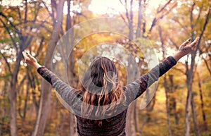 Young woman connecting with nature with open arms showing gratitude for life, Mindfulness Concept photo