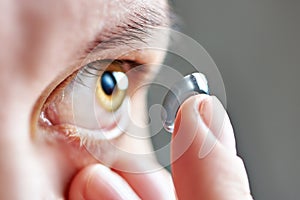 Young woman with contact lens