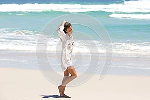 Young woman in contemplation walking on the beach