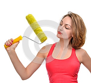 Young woman contractor worker with construction paint brush roll