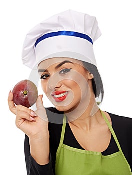 Young woman cook holding mango fruit