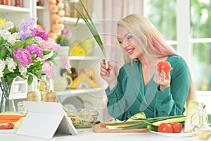 Young woman cooking healthy food in kitchen