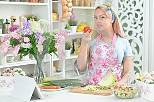 Young woman cooking healthy food in kitchen