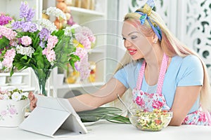 Young woman cooking healthy food in kitchen