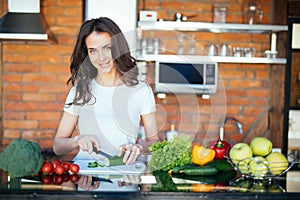 Young woman cooking healthy food in the morning