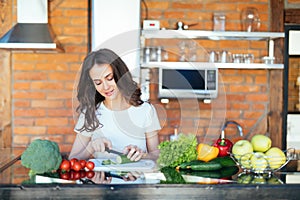 Young woman cooking healthy food in the morning