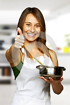 Young woman cooking healthy food - ok sign