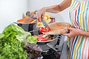 Young woman cooking in her modern kitchen