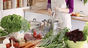 Young Woman Cooking in the kitchen. Healthy Food
