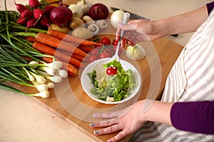 Young Woman Cooking in the kitchen. Healthy Food