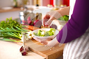 Young Woman Cooking in the kitchen. Healthy Food