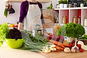 Young Woman Cooking in the kitchen. Healthy Food