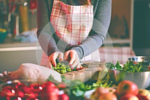 Young Woman Cooking in the kitchen. Healthy Food for Christmas stuffed duck or Goose