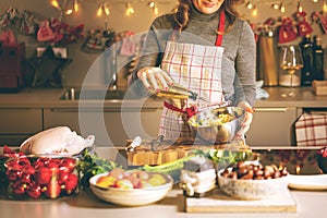 Young Woman Cooking in the kitchen. Healthy Food for Christmas stuffed duck or Goose