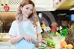 Young Woman Cooking in the kitchen. Healthy Food - Vegetable Salad. Diet. Dieting Concept. Healthy Lifestyle. Cooking At