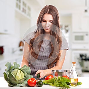 Young Woman Cooking in the kitchen. Healthy Food -