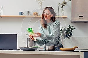 Young woman cooking in the kitchen at home