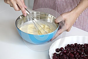 Young woman cooking in kitchen. preparation of a French pie with