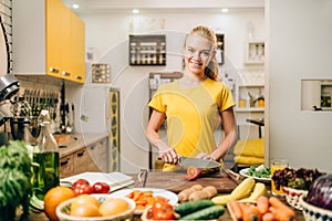 Young woman cooking on recipes, healthy bio food