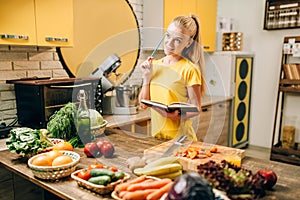 Young woman cooking on recipes, healthy eco food