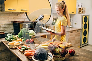 Young woman cooking on recipes, healthy eco food