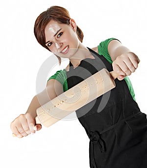 Young woman cooking with a roller