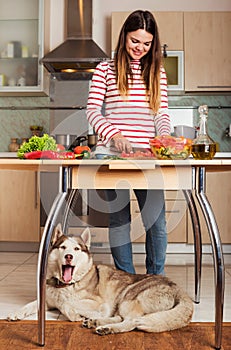 Young Woman Cooking Vegetable Salad